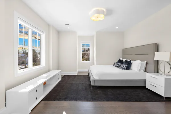 a spacious bathroom with a double vanity sink toilet and a mirror