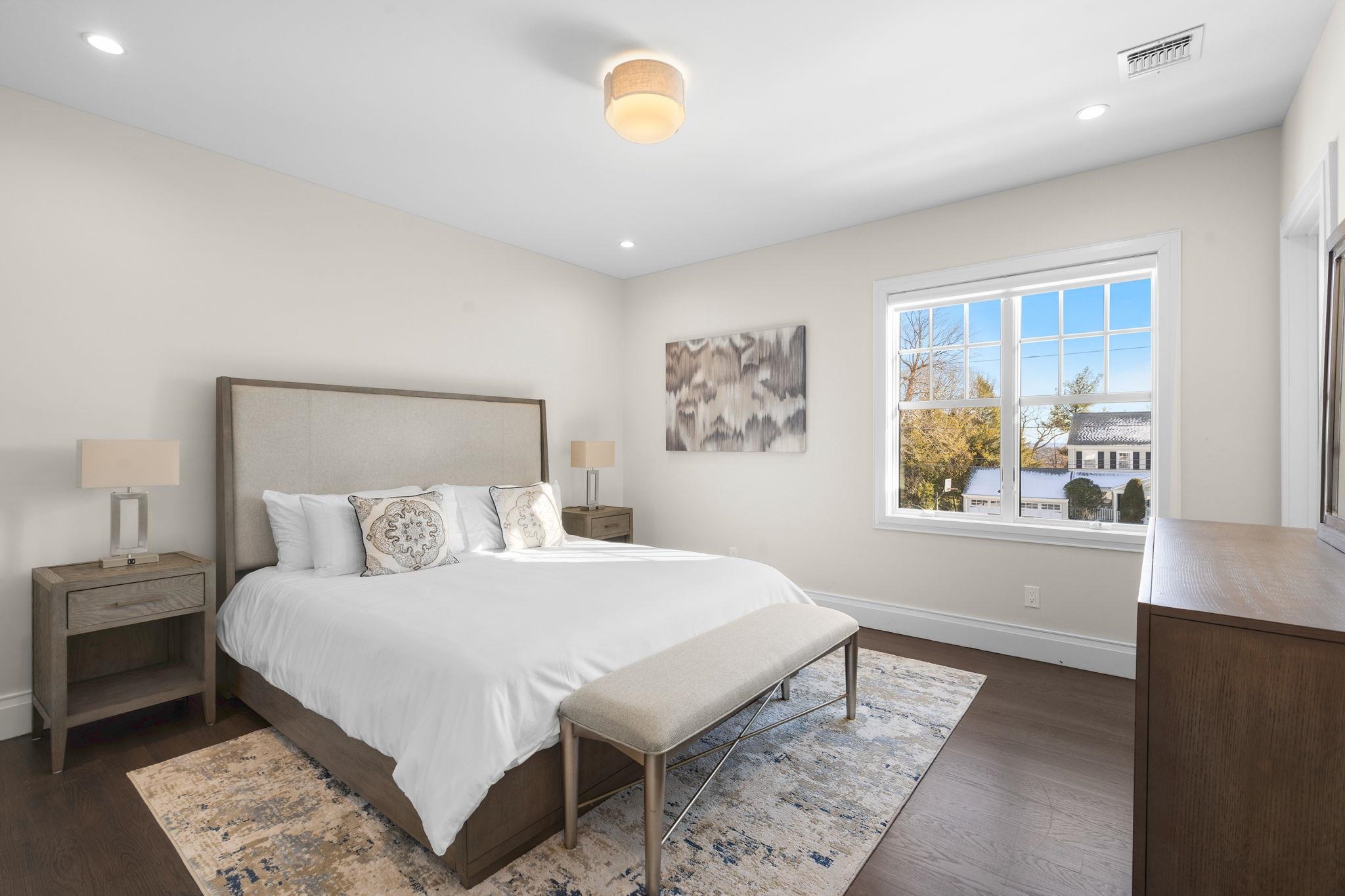396 Knollwood Road Ridgewood, NJ 07450 - Photo 37 of 50 a bedroom with a bed a painting on the wall and a window