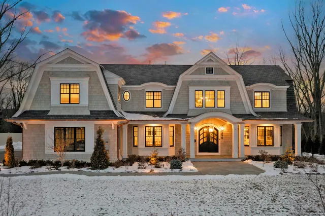 a view of a hallway with wooden floor and a cabinet