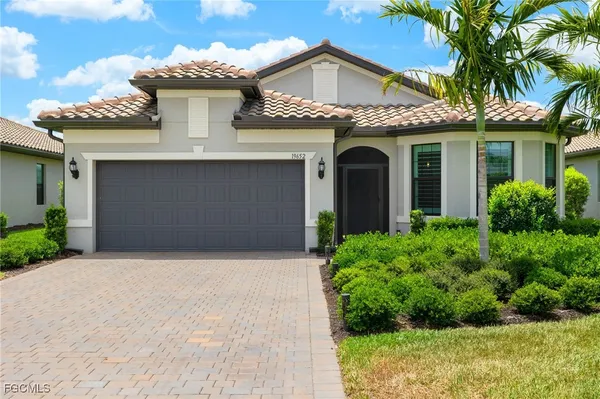 a front view of a house with a garden
