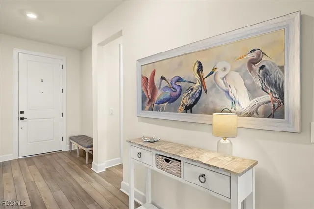 a view of a kitchen with a stove and a painting on the wall