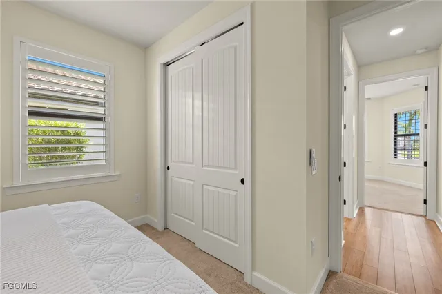 a view of a bedroom with cabinet and windows