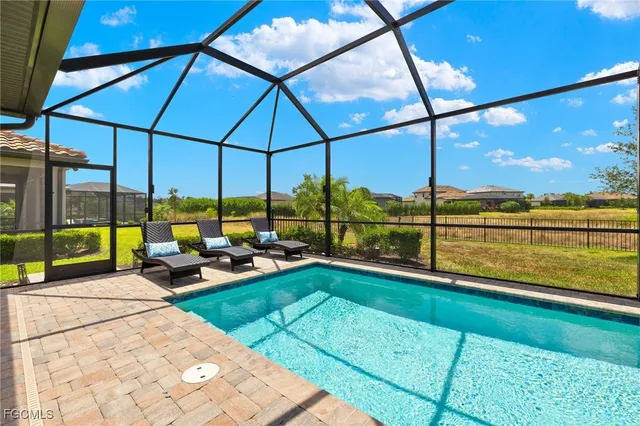 a view of swimming pool with a lounge chairs