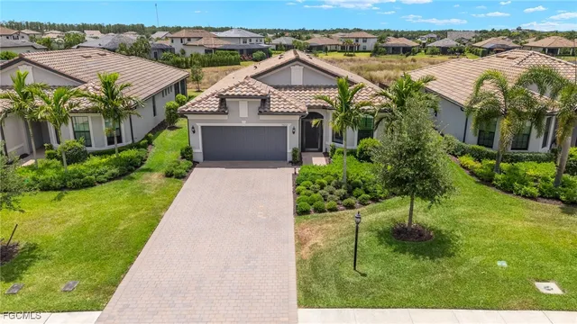 a aerial view of a house with a yard and lake view