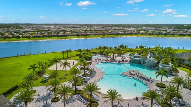 a room with lots of tables a large window and chairs