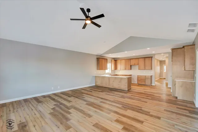 a view of kitchen with kitchen island and stainless steel appliances
