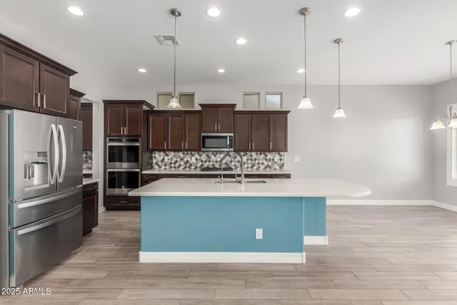 a large kitchen with stainless steel appliances kitchen island a large island in the center