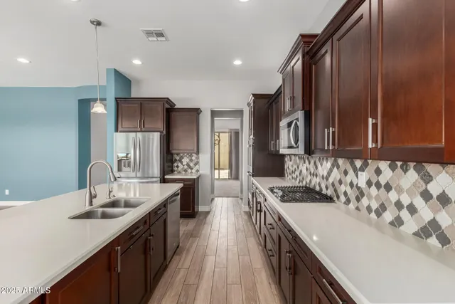 a kitchen with a sink stove and refrigerator