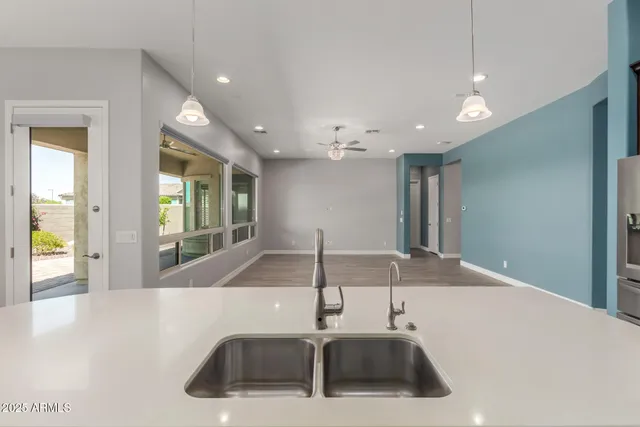 a kitchen with kitchen island a sink and a refrigerator