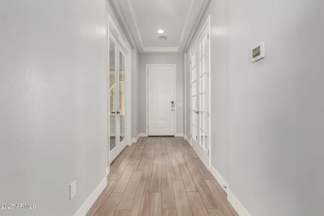 a view of a hallway with wooden floor