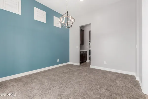 a view of an empty room with a chandelier