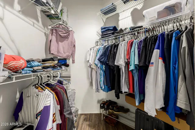 a view of walk in closet with clothes