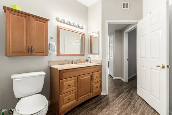 a bathroom with a toilet a sink and a mirror