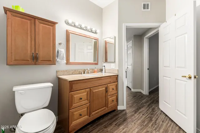 a bathroom with a toilet a sink and a mirror