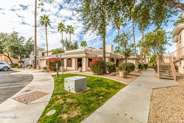 a front view of house with yard and trees around