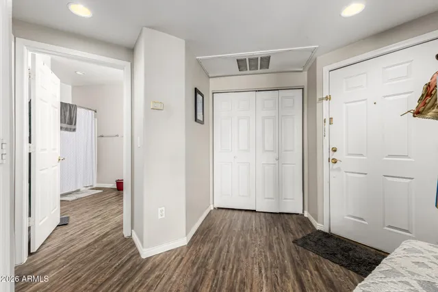 a view of a bedroom with wooden floor