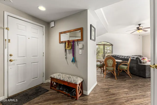 a living room with furniture a wooden floor and a rug