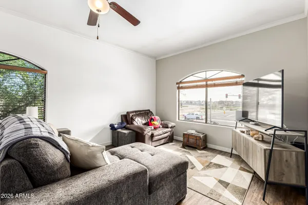 a living room with furniture and large windows