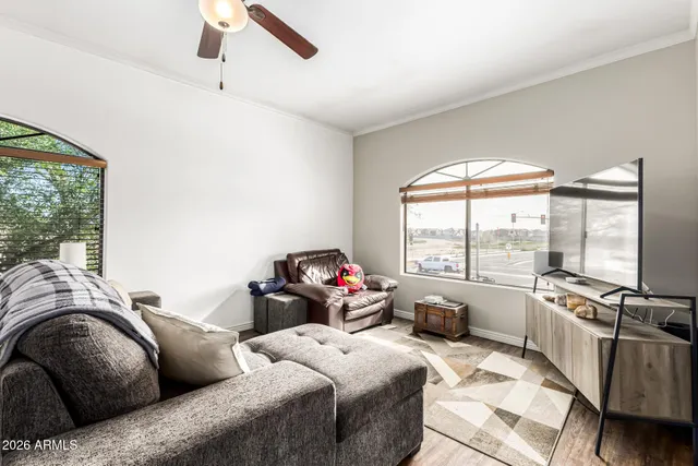 a living room with furniture and large windows