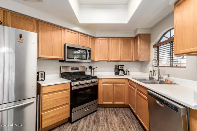 a kitchen with a sink stove and refrigerator