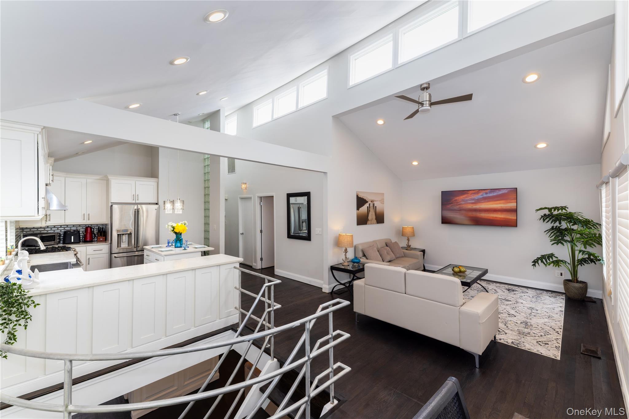 2590 Riverside Drive Wantagh, NY 11793 - Photo 4 of 27 Expansive open-concept living area featuring a vaulted ceiling and dark wood-finish flooring