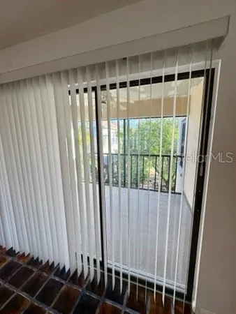 a view of a livingroom with wooden floor and a window