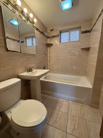 a bathroom with a toilet a sink and bathtub