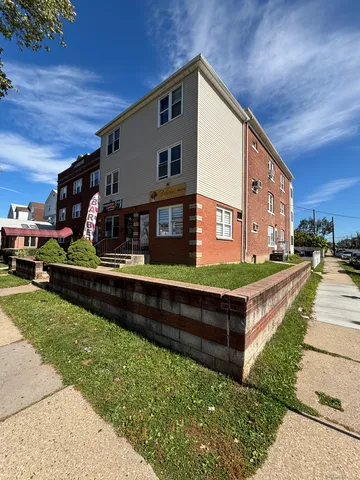 a front view of a house with a yard table and chairs