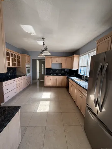 a large kitchen with cabinets and stainless steel appliances