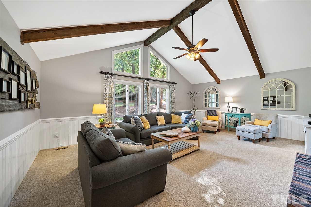 8609 Langtree Lane Raleigh, NC 27613 - Photo 4 of 30 a living room with furniture a ceiling fan and a rug