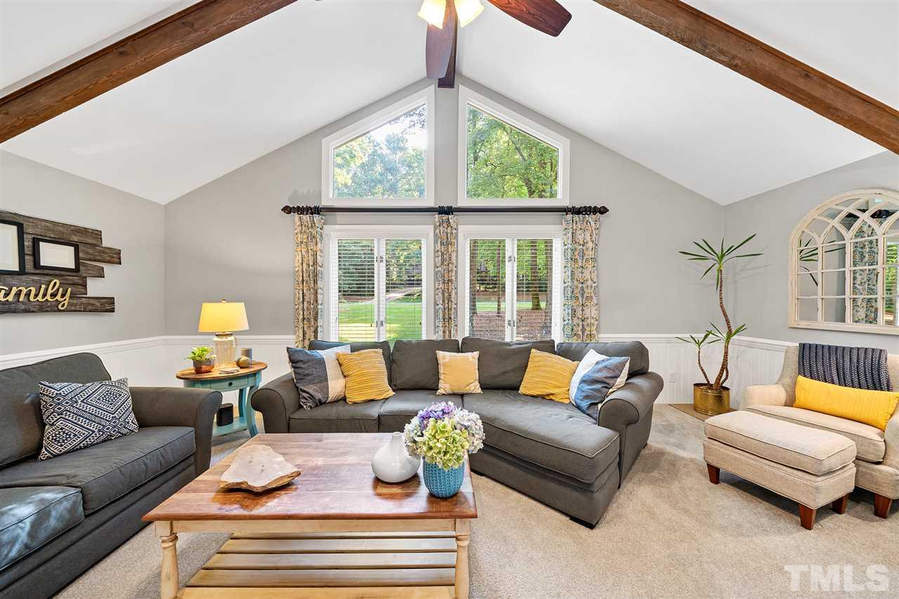 8609 Langtree Lane Raleigh, NC 27613 - Photo 5 of 30 a living room with furniture and a large window