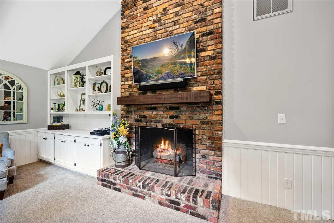 8609 Langtree Lane Raleigh, NC 27613 - Photo 7 of 30 a living room with furniture and a fireplace