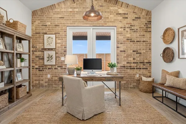 an empty room with wooden floor and mirror