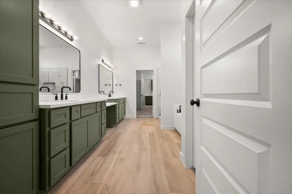 a spacious bathroom with a double vanity sink mirror and shower