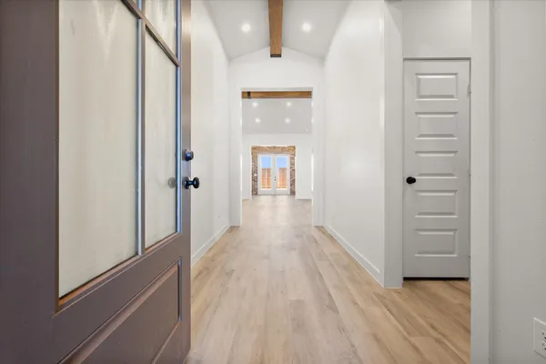 a view of a hallway with wooden floor