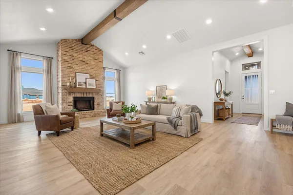 a living room with furniture fireplace and a table