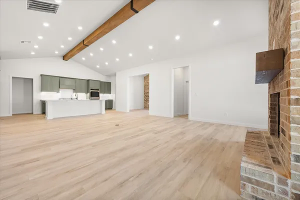 a view of kitchen with refrigerator and microwave