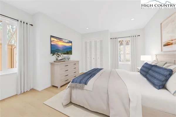 a bedroom with a bed and a television