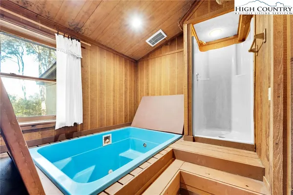 a bedroom with furniture and a large window