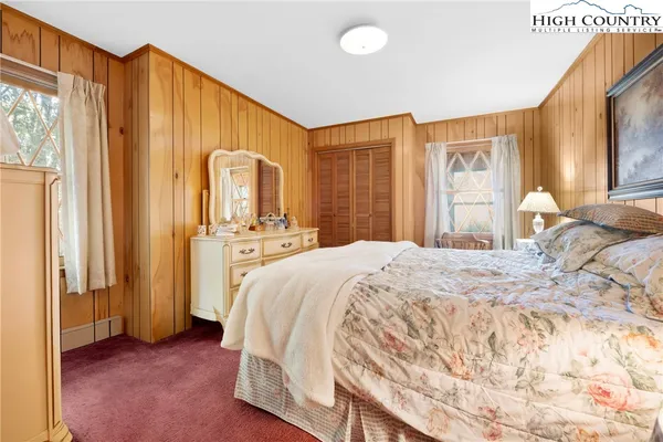 a bedroom with a bed and a large mirror