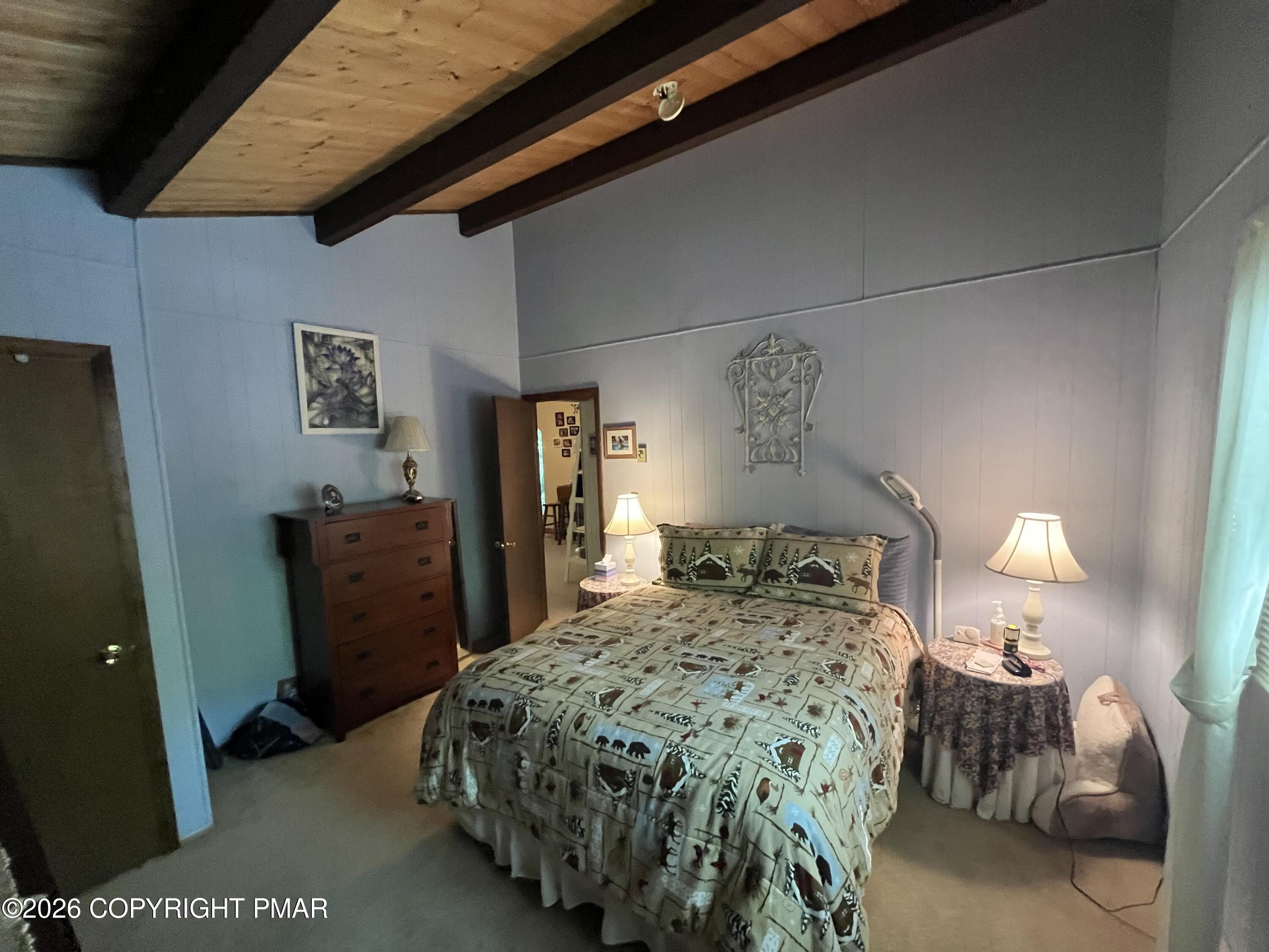 5970 Decker Road Bushkill, PA 18324 - Photo 20 of 26 a bedroom with a bed and a lamp on dresser