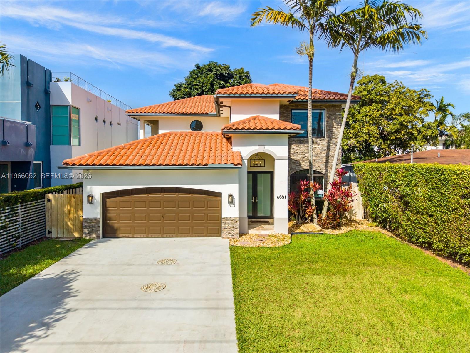 6001 Southwest 28th Street Miami, FL 33155 - Photo 1 of 30 a view of a house with a yard and potted plants