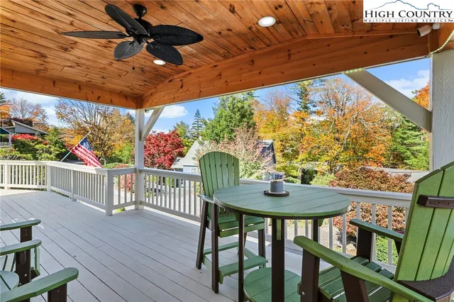 a view of balcony with wooden floor and outdoor seating
