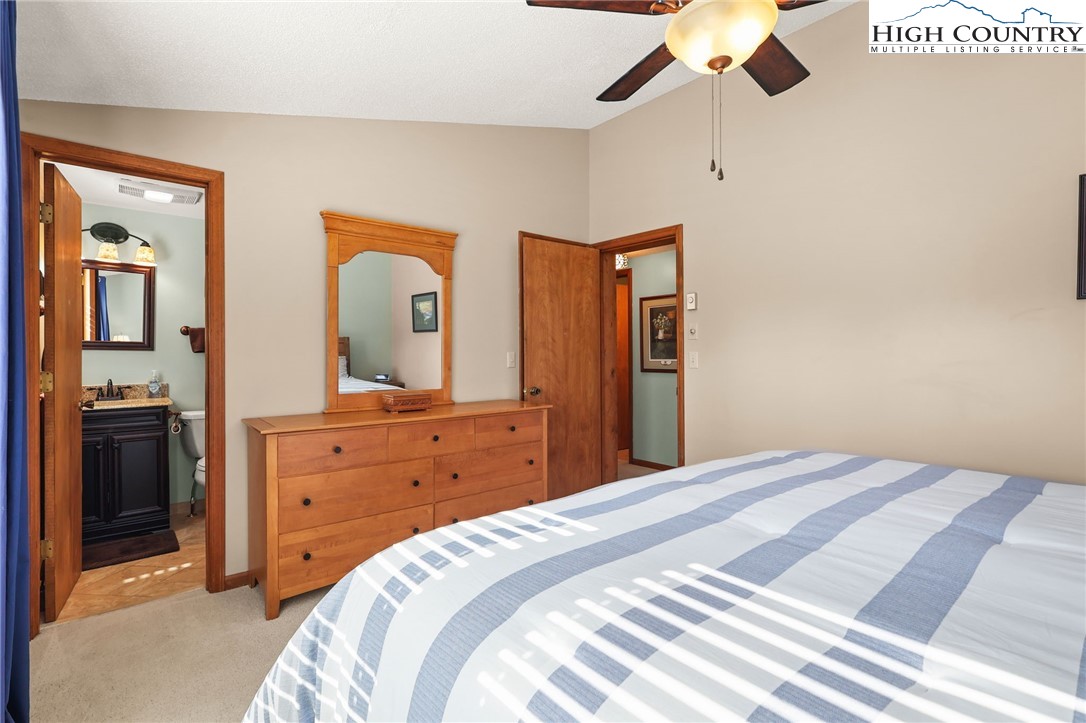 228 Snowshoe Loop Newland, NC 28657 - Photo 22 of 50 a bedroom with a bed and a dresser
