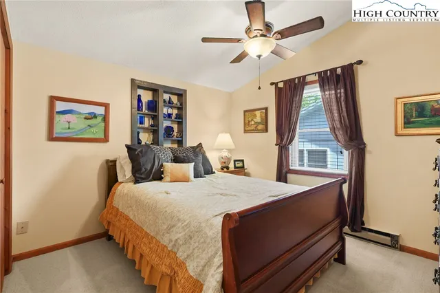 a bed room with a bed and a chandelier