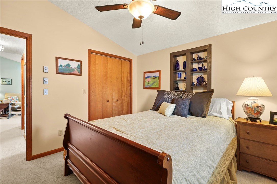 228 Snowshoe Loop Newland, NC 28657 - Photo 25 of 50 a bed room with a bed and a chandelier