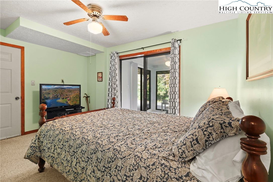 228 Snowshoe Loop Newland, NC 28657 - Photo 32 of 50 a bedroom with a bed and wooden floor