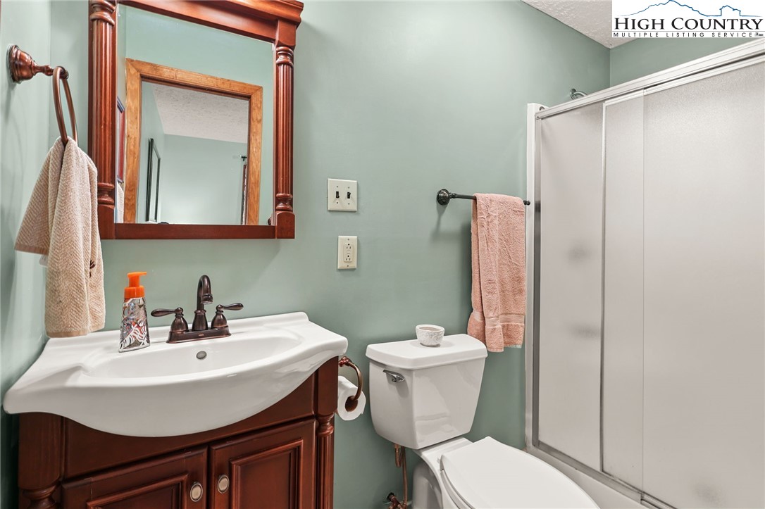 228 Snowshoe Loop Newland, NC 28657 - Photo 33 of 50 a bathroom with a sink toilet and mirror