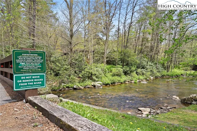 a view of a balcony with wooden floor and fence