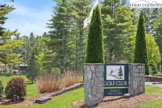 a view of field with grass and trees